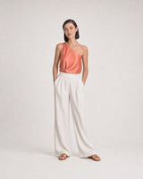 Full-body coral and ivory summer portrait featuring the Delphine toggle