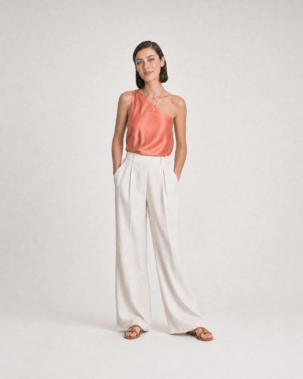 Full-body coral and ivory summer portrait featuring the Delphine toggle