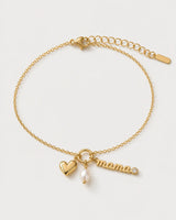 Elara gold mama charm bracelet on a seamless pale dove-grey studio background