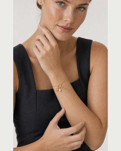 Human-scale portrait of the model wearing the Elara mama charm bracelet