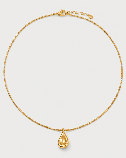 Elara gold sculptural droplet necklace on a seamless pale dove-grey studio background