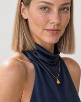 Human-scale close view of the Elara sculptural droplet necklace