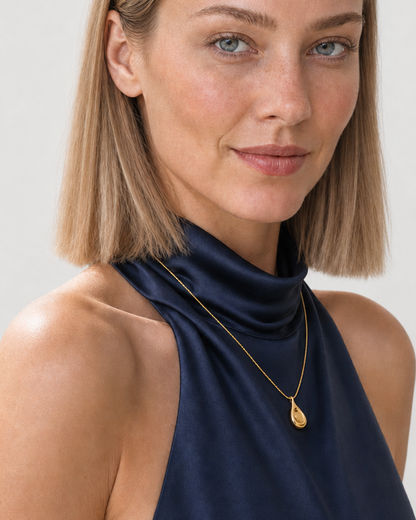 Human-scale close view of the Elara sculptural droplet necklace