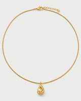 Elara gold sculptural droplet necklace on seamless pale neutral grey