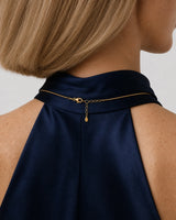 Rear nape view of Helena wearing the Elara gold necklace with clasp and extender visible