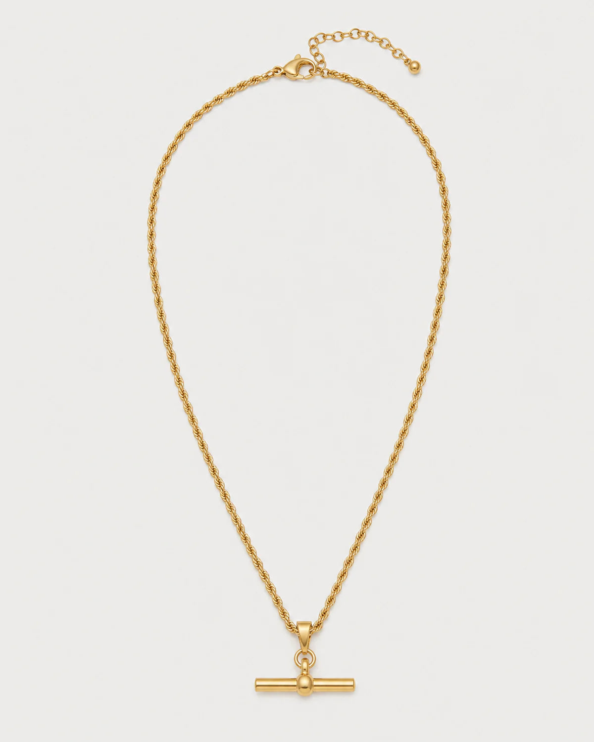 Elodie gold rope T-bar necklace on a pale dove-grey background
