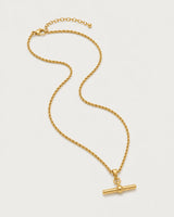 Elodie gold-tone rope T-bar necklace in an alternate arrangement on pale grey