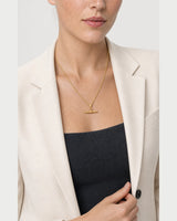 Model holding her blazer lapel while wearing the Elodie necklace