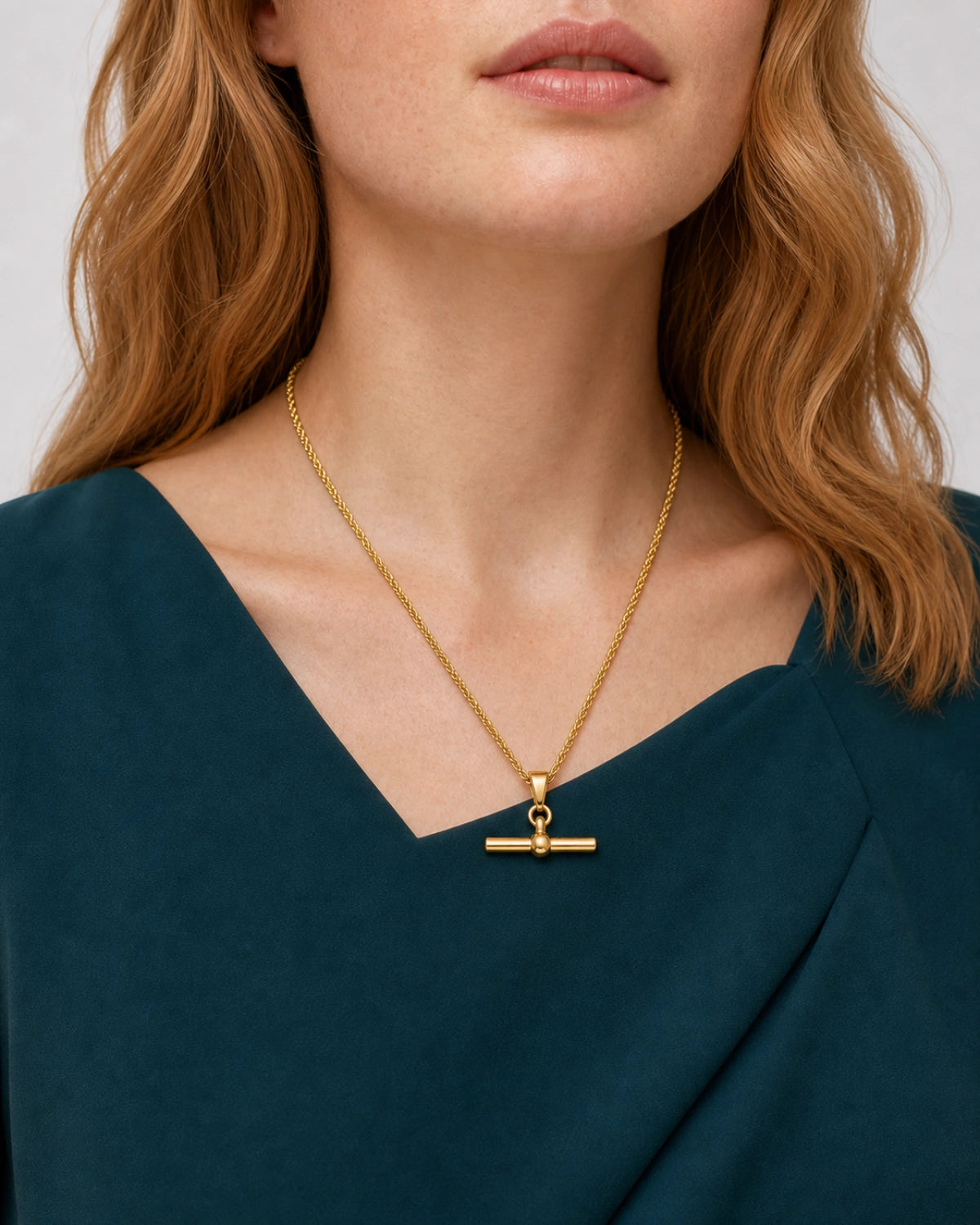 Eye-free oblique neckline view of Juliet wearing the Elodie T-bar necklace