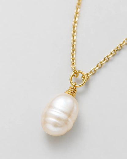 Macro view of the organic Elowen freshwater pearl and gold wire wrap