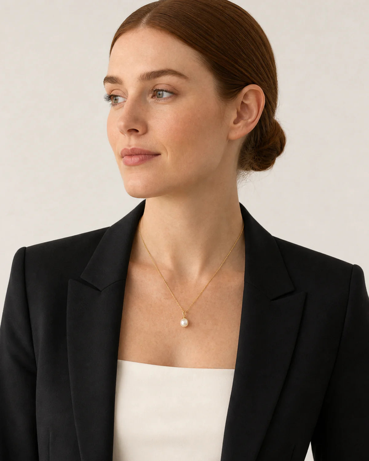 Model in black tailoring wearing Elowen pearl necklace