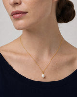 Three-quarter worn view of the Elowen fine gold chain and pearl pendant