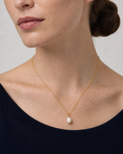 Three-quarter worn view of the Elowen fine gold chain and pearl pendant