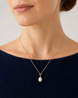 Close wearing view of the Elowen gold chain and organic freshwater pearl