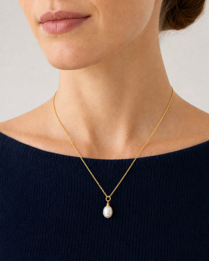 Close wearing view of the Elowen gold chain and organic freshwater pearl
