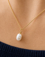 Extreme collarbone macro of the Elowen organic pearl and gold wire wrap