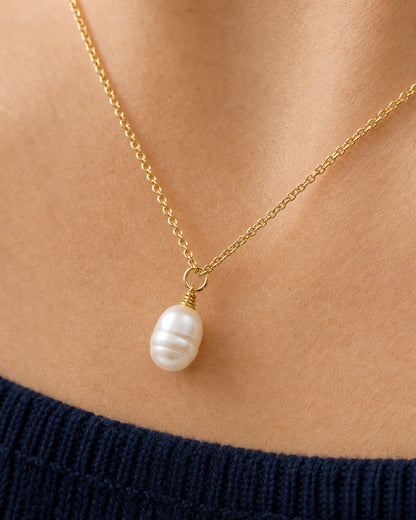 Extreme collarbone macro of the Elowen organic pearl and gold wire wrap