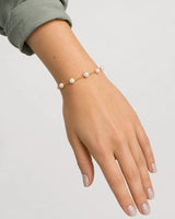 Relaxed wrist-down view of the Elowen five-pearl station bracelet