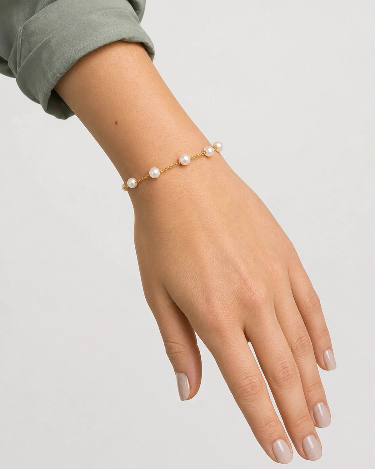 Relaxed wrist-down view of the Elowen five-pearl station bracelet