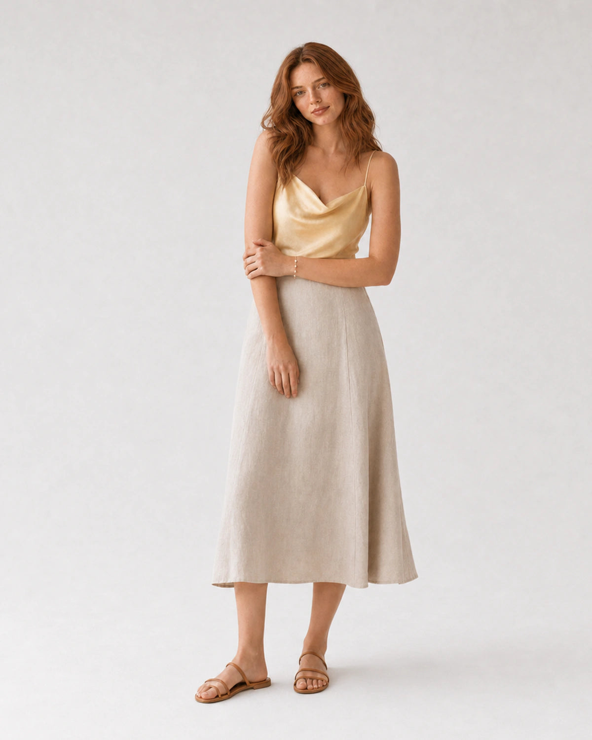 Full-body butter-yellow silk and oat linen portrait featuring the Elowen bracelet