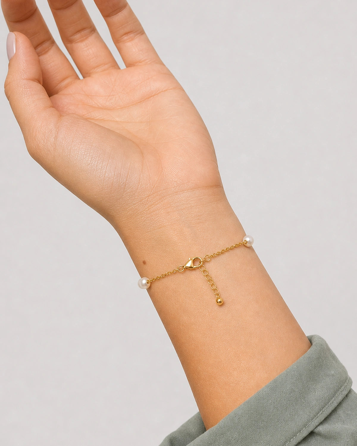 Palm-up view of the Elowen lobster clasp and bead-ended extender