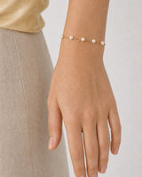 Human-scale view of the Elowen five-pearl gold bracelet
