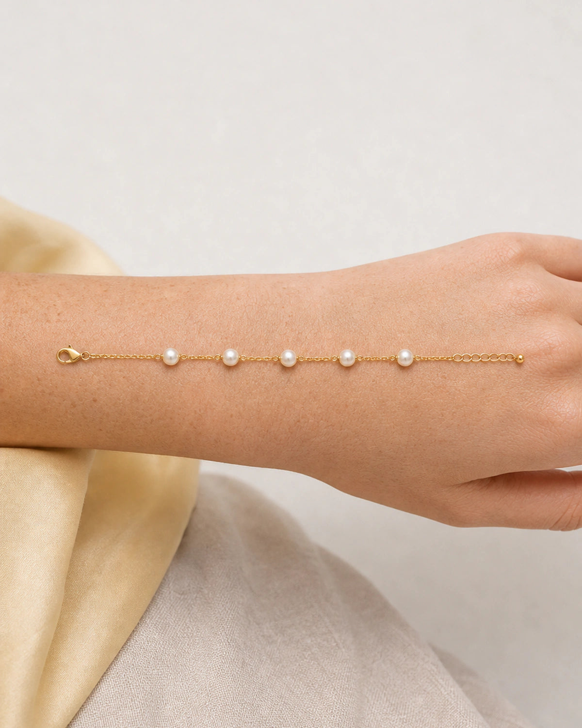 Elowen bracelet detail showing five pearls, lobster clasp and bead-ended extender