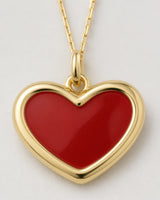 Macro view of the Estelle glossy red enamel heart and gold border