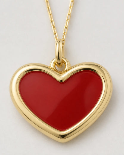 Macro view of the Estelle glossy red enamel heart and gold border