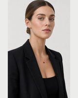 British model in all-black tailoring wearing the Estelle necklace
