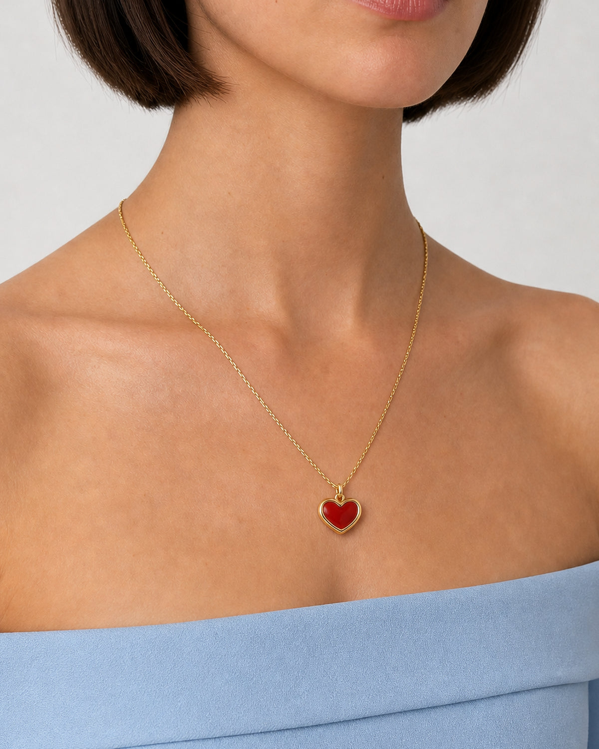 Three-quarter wearing view of the Estelle red enamel heart necklace