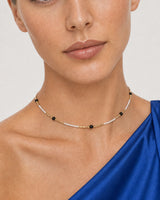 Close wearing view of the Isla ivory seed beads, black accents and gold spacers