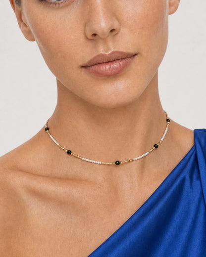 Close wearing view of the Isla ivory seed beads, black accents and gold spacers