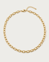 Liora gold orbit-link chain necklace on a seamless pale dove-grey background