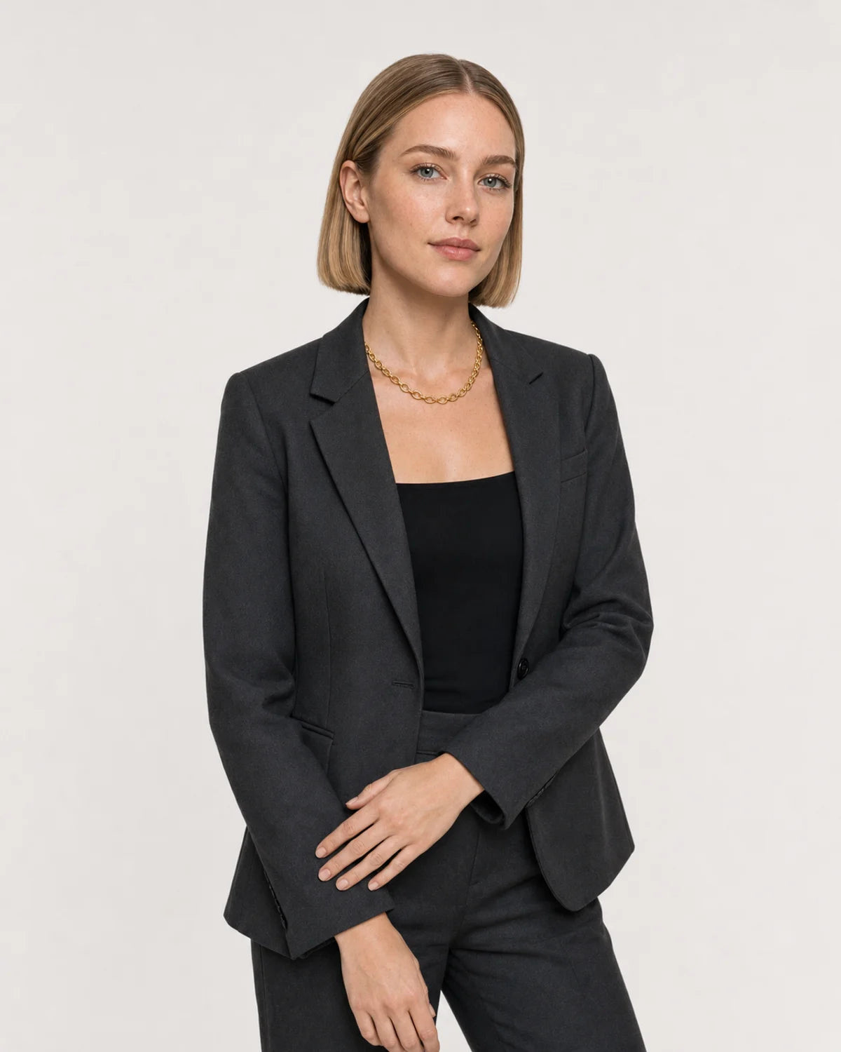 Wider studio portrait showing the Liora orbit chain at natural collar scale