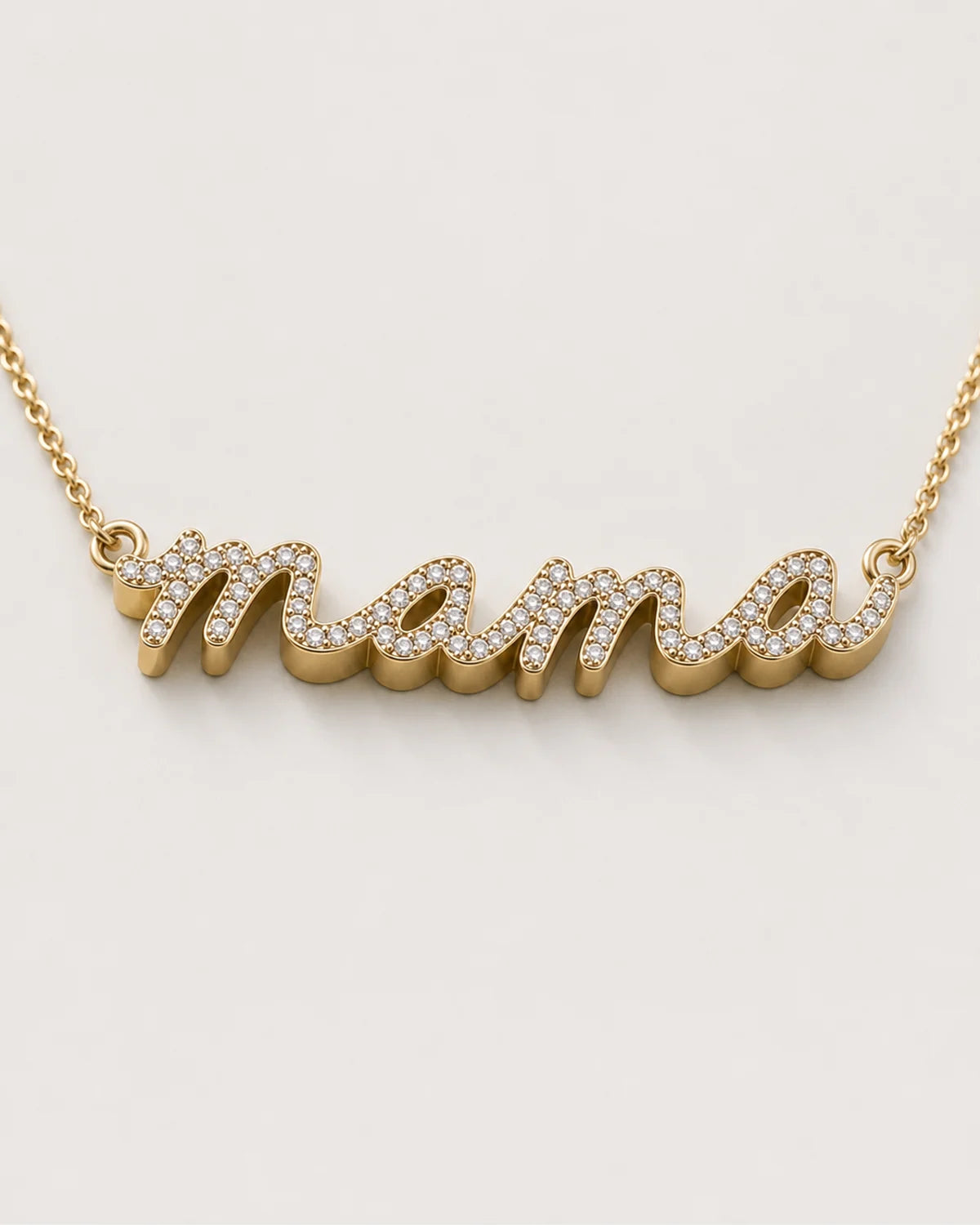 Macro of the Liora lowercase pavé mama script and raised polished gold sidewall