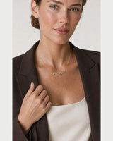 Human-scale portrait of the model wearing the Liora sculpted mama necklace