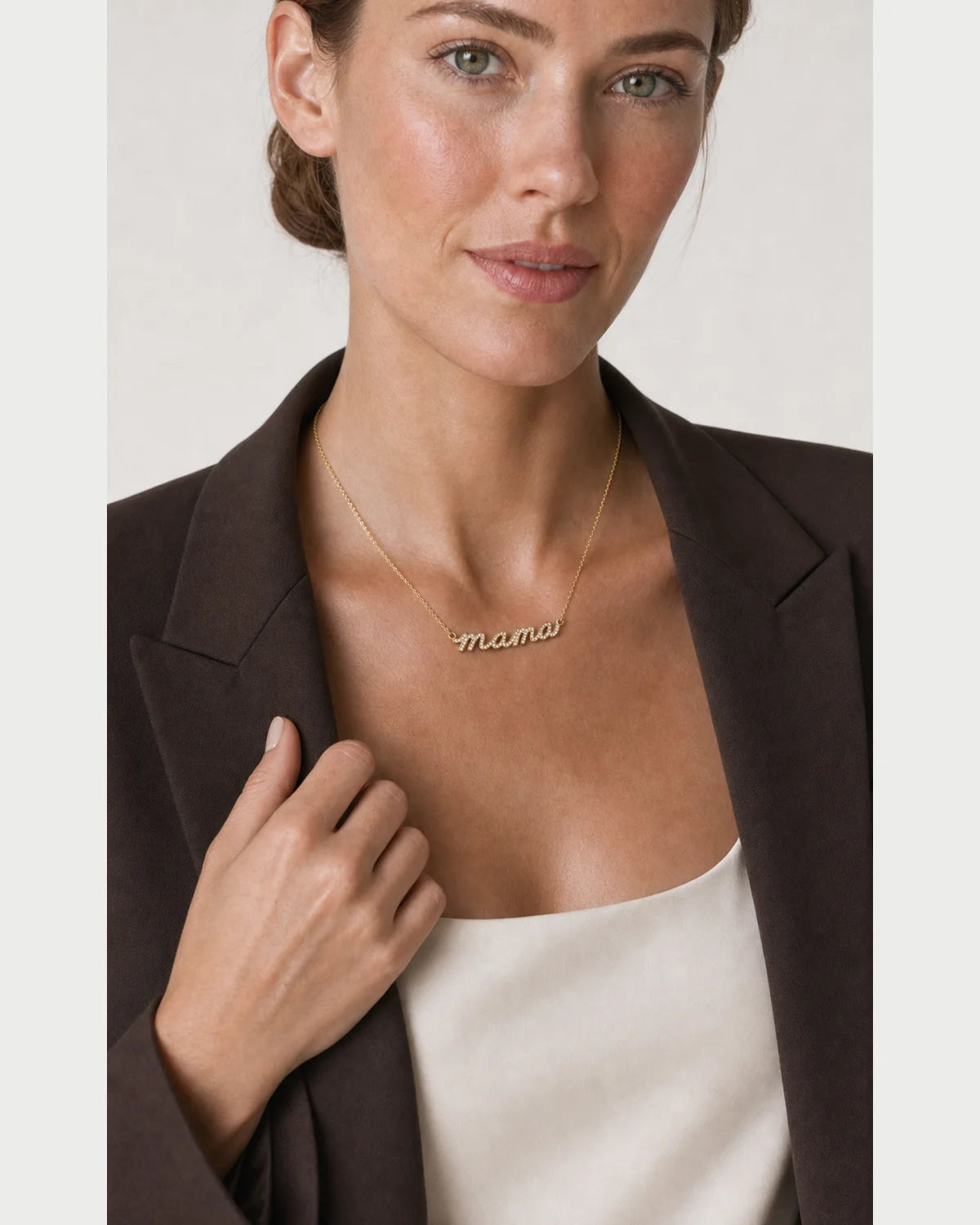 Human-scale portrait of the model wearing the Liora sculpted mama necklace