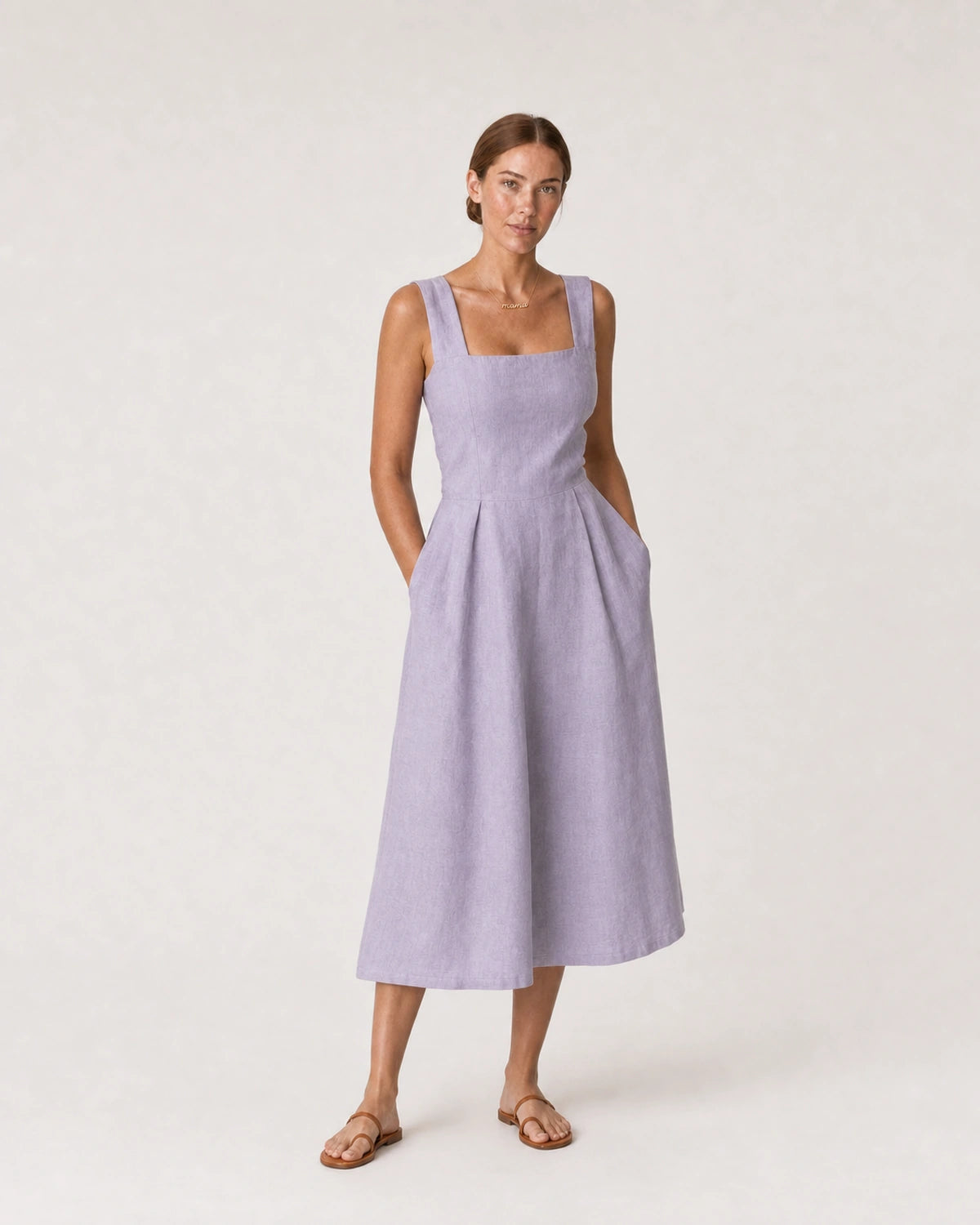 Wide studio portrait in a lavender linen midi dress featuring the Liora mama necklace