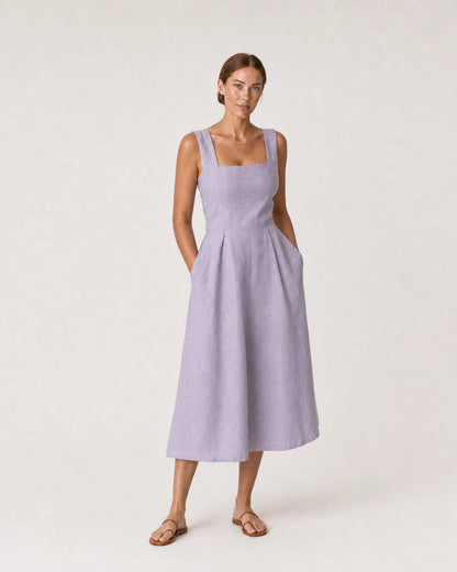 Wide studio portrait in a lavender linen midi dress featuring the Liora mama necklace