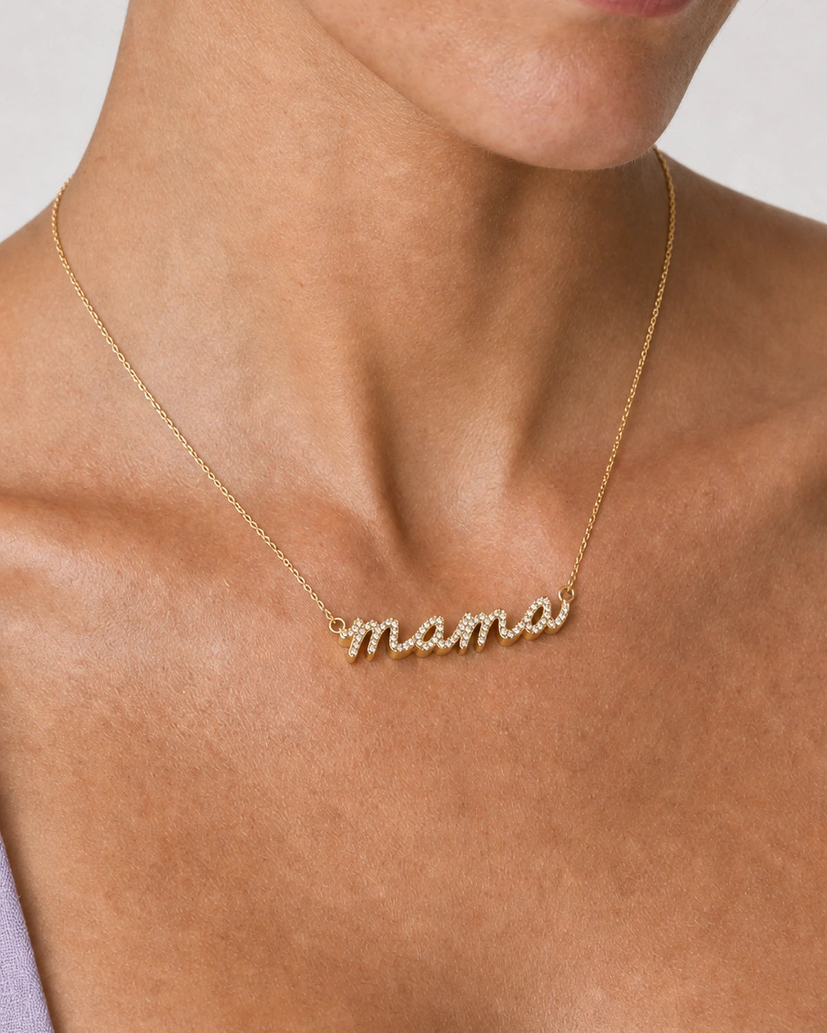 Extreme on-body macro of the Liora pave mama script and raised gold sidewall