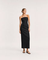 Wide studio portrait in a black linen column dress featuring Lisette gold huggies
