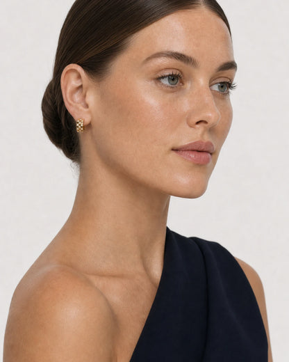 Three-quarter portrait of Cecily wearing the gold Lisette huggies