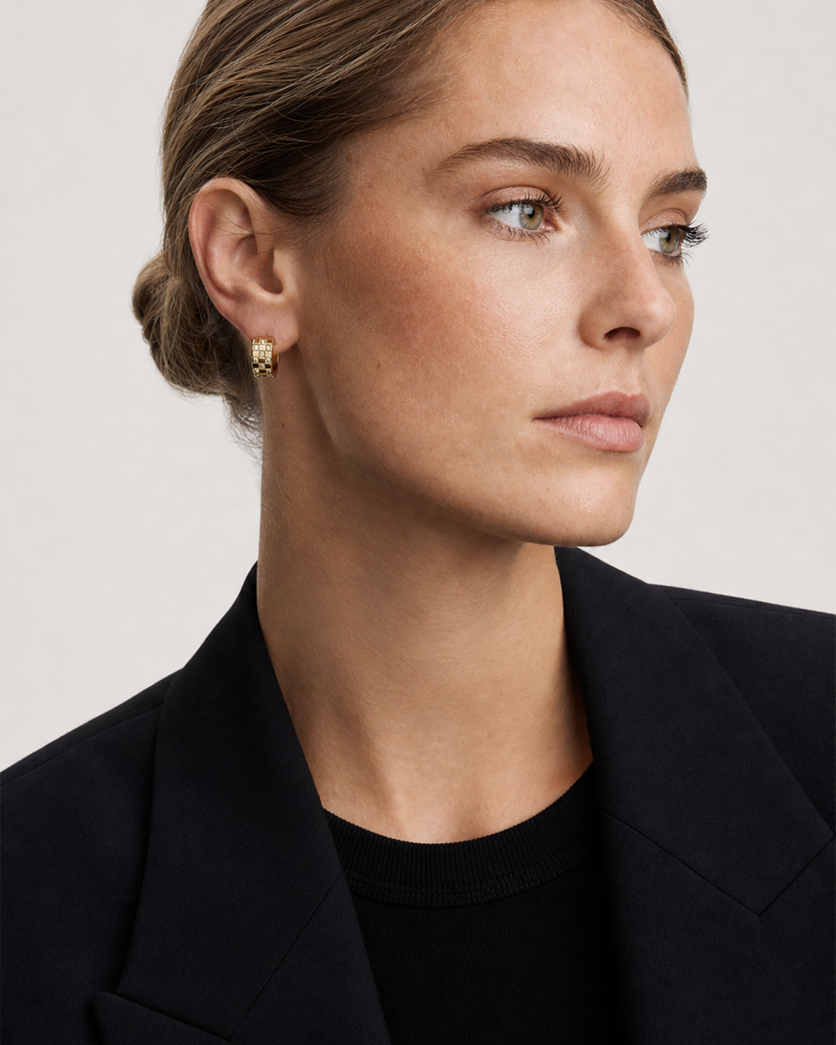 British model aged 28 wearing Lisette gold checkerboard huggies