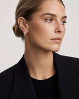 British model aged 28 wearing Lisette gold checkerboard huggies