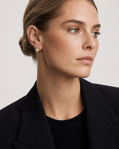 British model aged 28 wearing Lisette gold checkerboard huggies