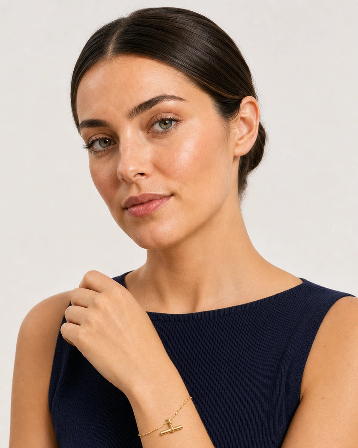 Model in a navy Riviera knit top wearing the Lucille beaded T-bar bracelet
