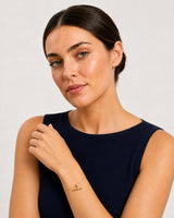 Alternate European-summer portrait featuring the Lucille gold T-bar bracelet