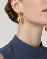 Tight ear and jaw close-up wearing a complete Luma gold teardrop earring
