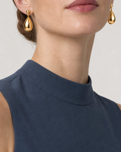 Eye-free mouth and chin crop wearing Luma gold teardrop earrings
